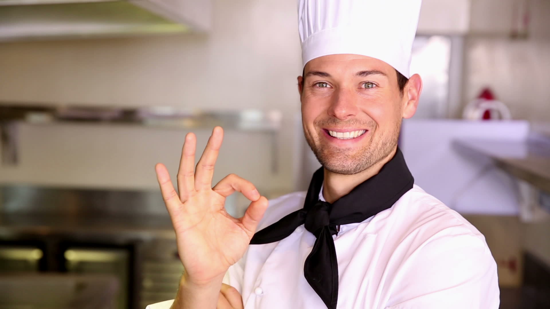 stock-footage-happy-chef-making-ok-sign-to-camera-in-commercial-kitchen.jpg
